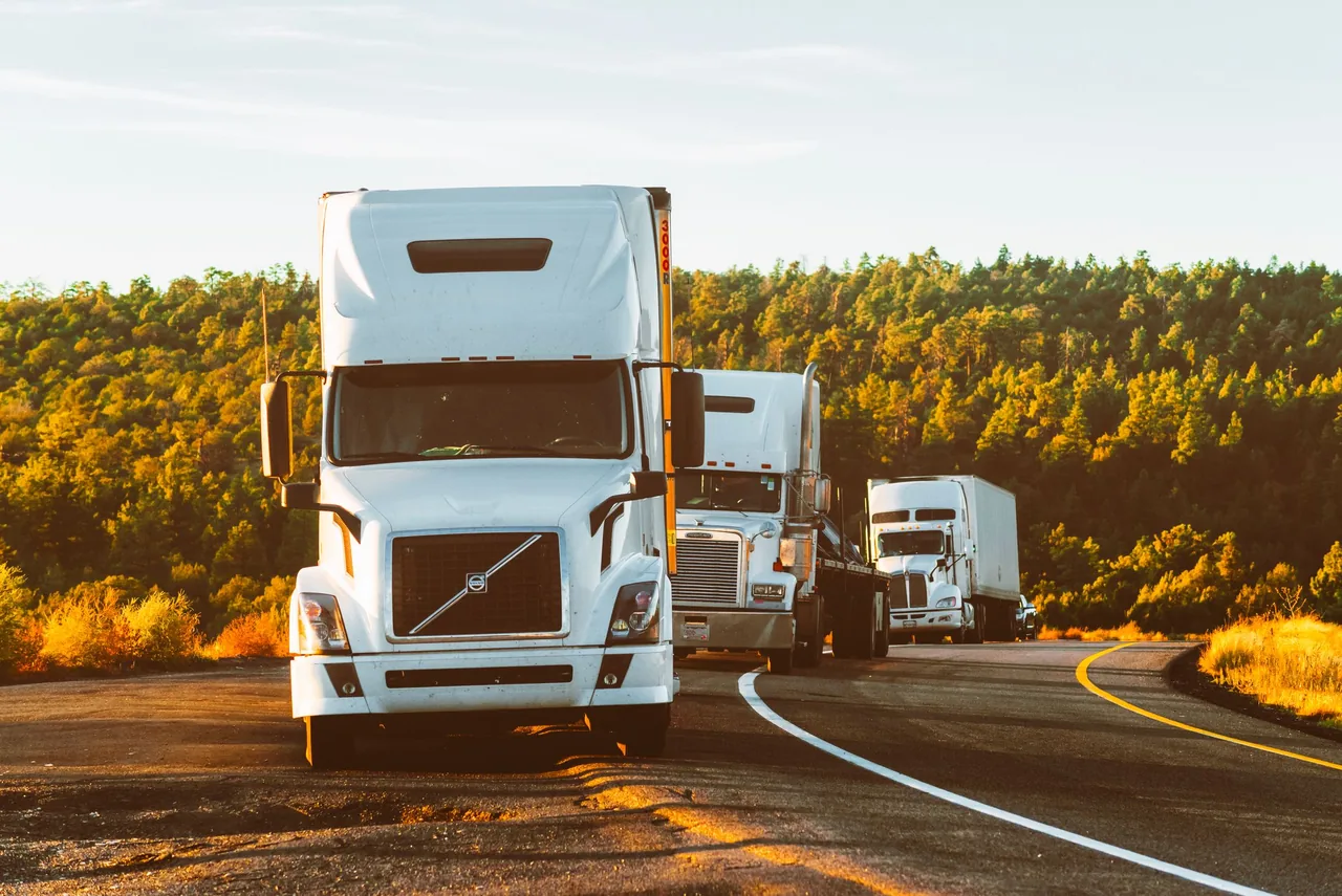 Semi trucks traveling along a highway